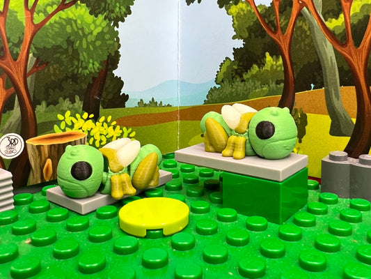 Toy forest scene with trees and animals on a green baseplate